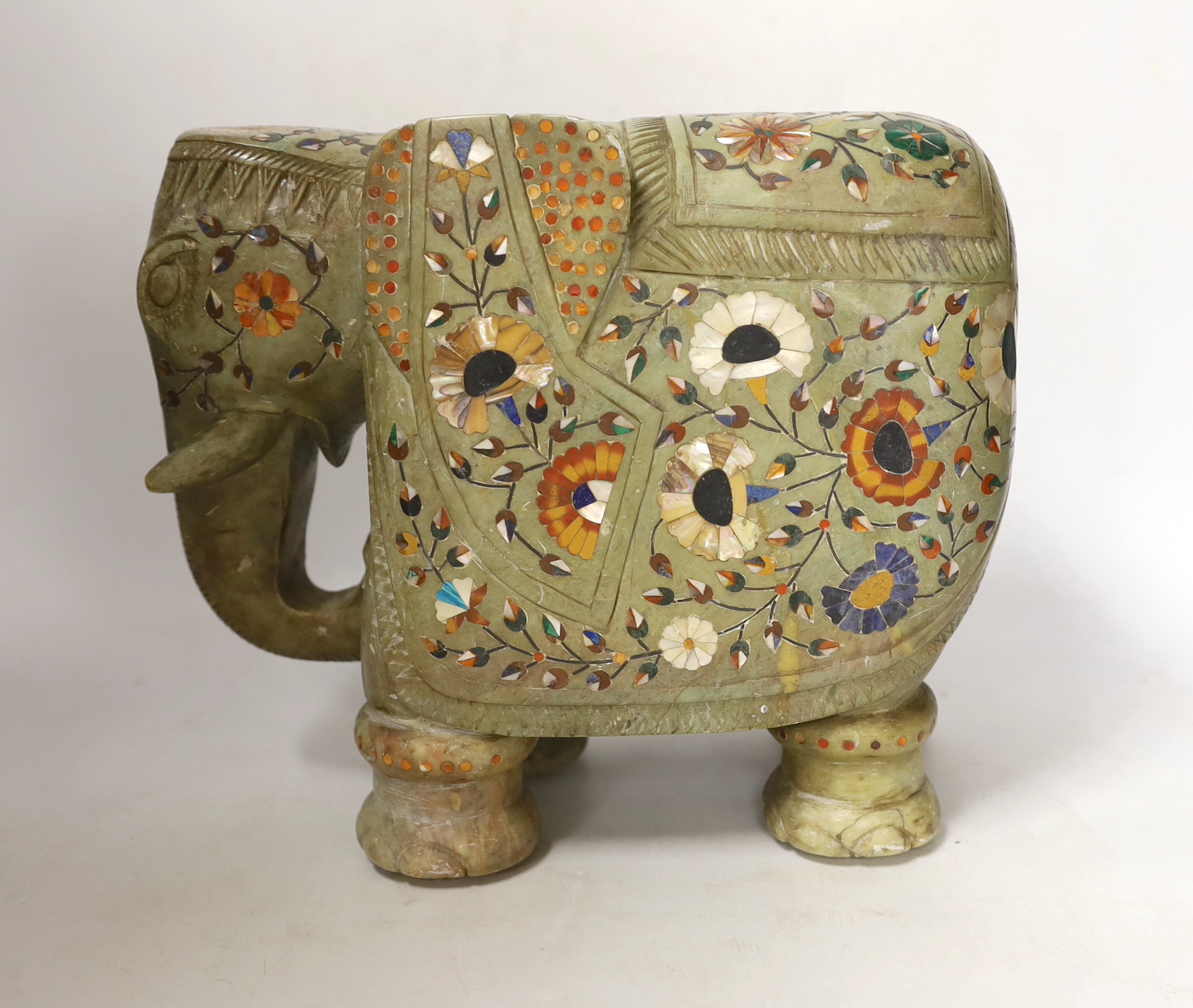 An Indian carved soapstone model of an elephant with semi precious stone inlay, 23cm